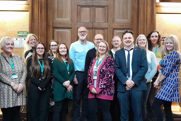 Team members posing at City Hall