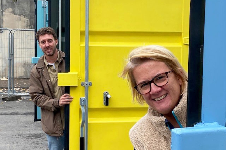 Cllr Harper and Fred Wyatt peering around container doors