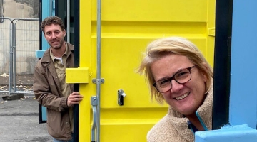 Cllr Harper and Fred Wyatt peering around container doors